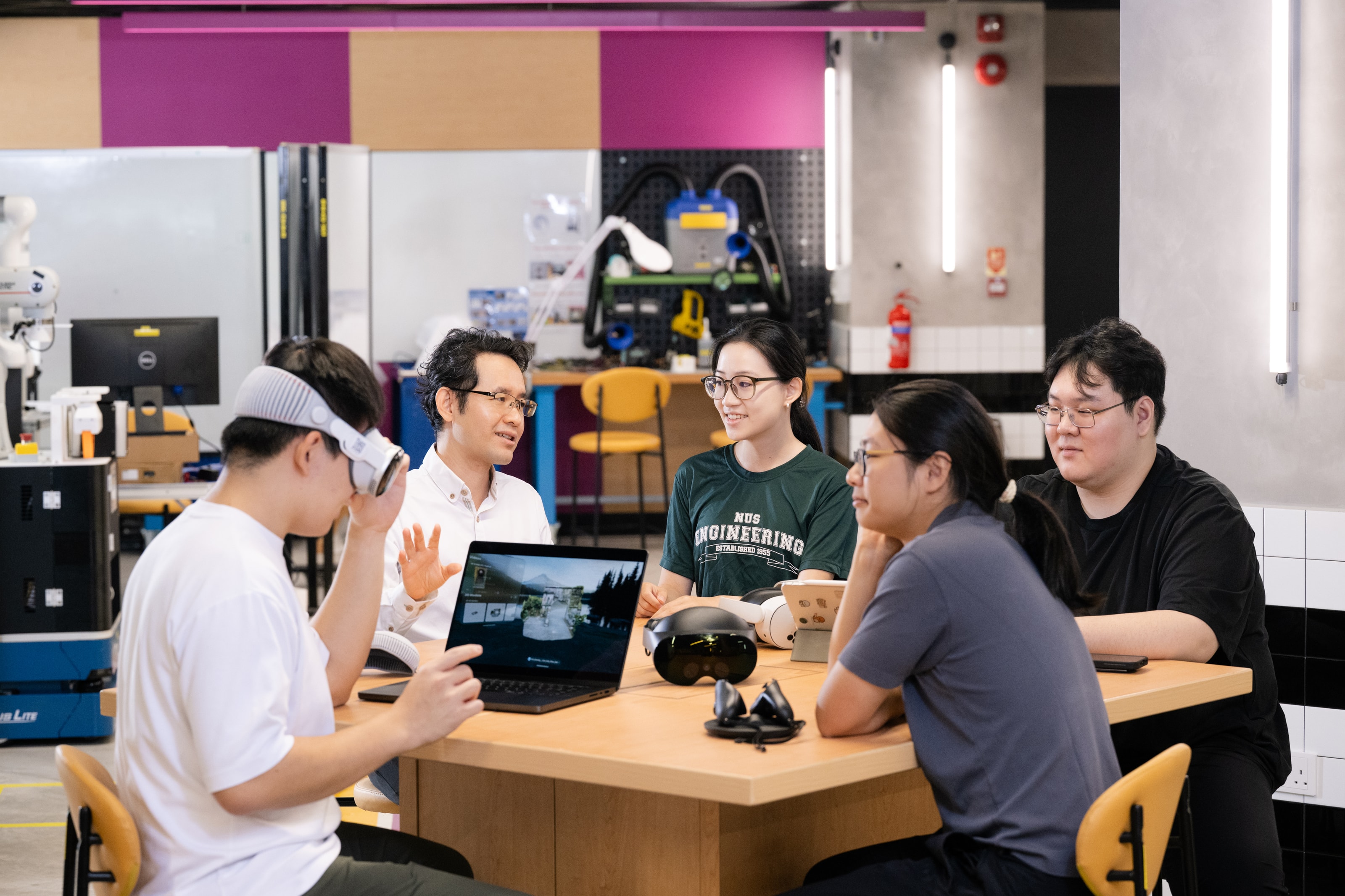 NUS CDE students working with technology